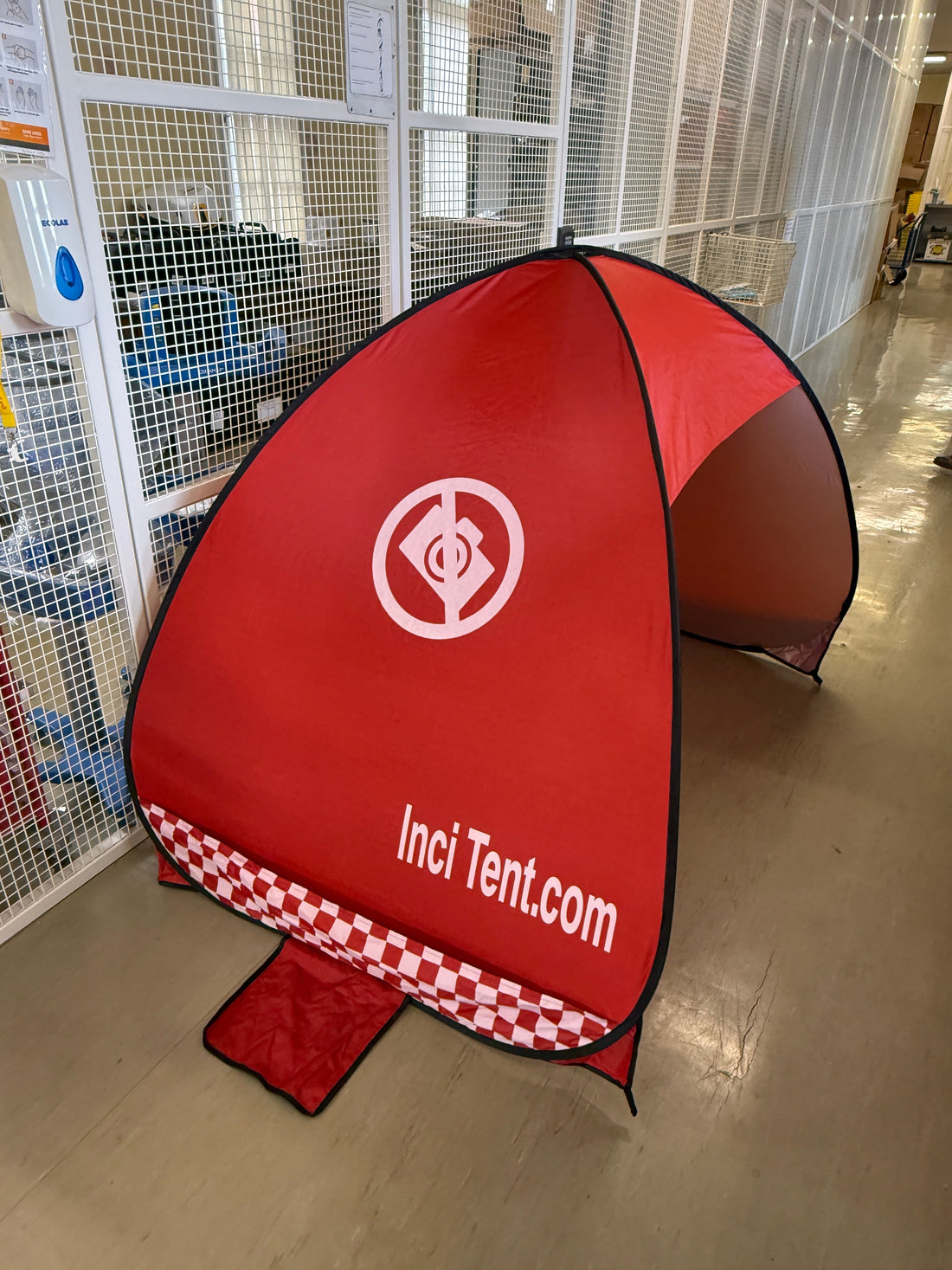 Red InciTent pop-up privacy tent with InciTent.com branding